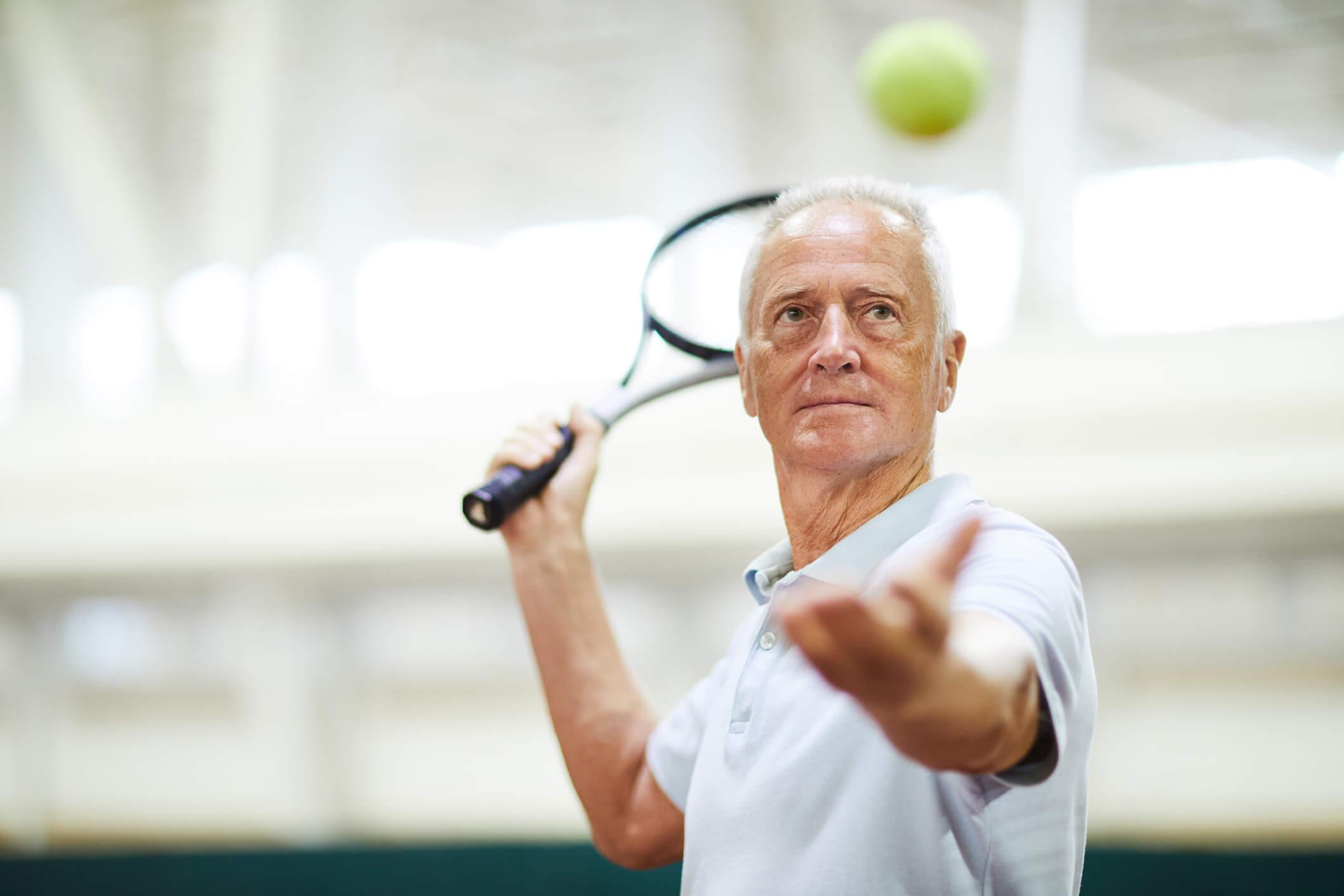 Older man playing tennis