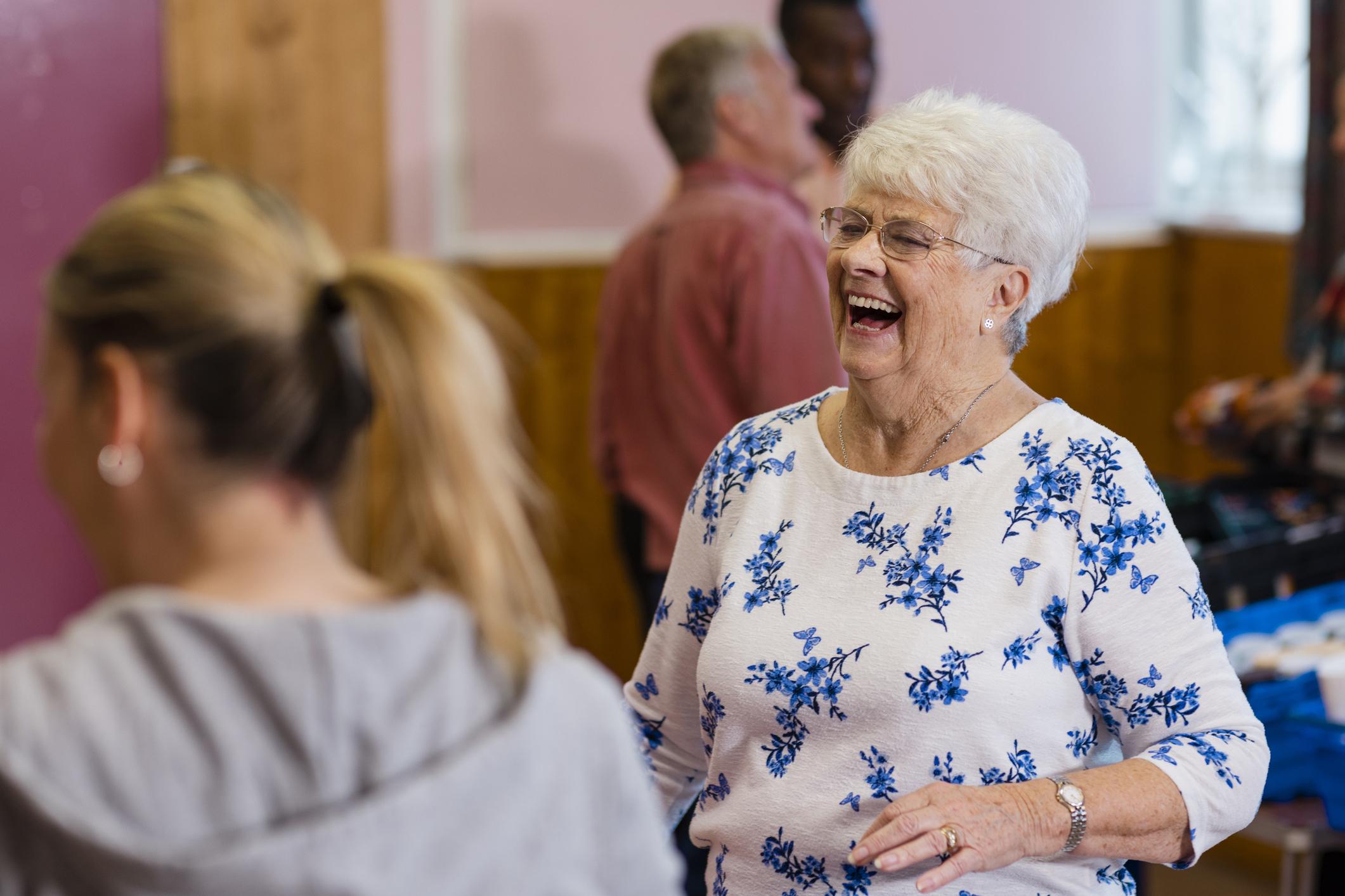 Woman laughing at a support group