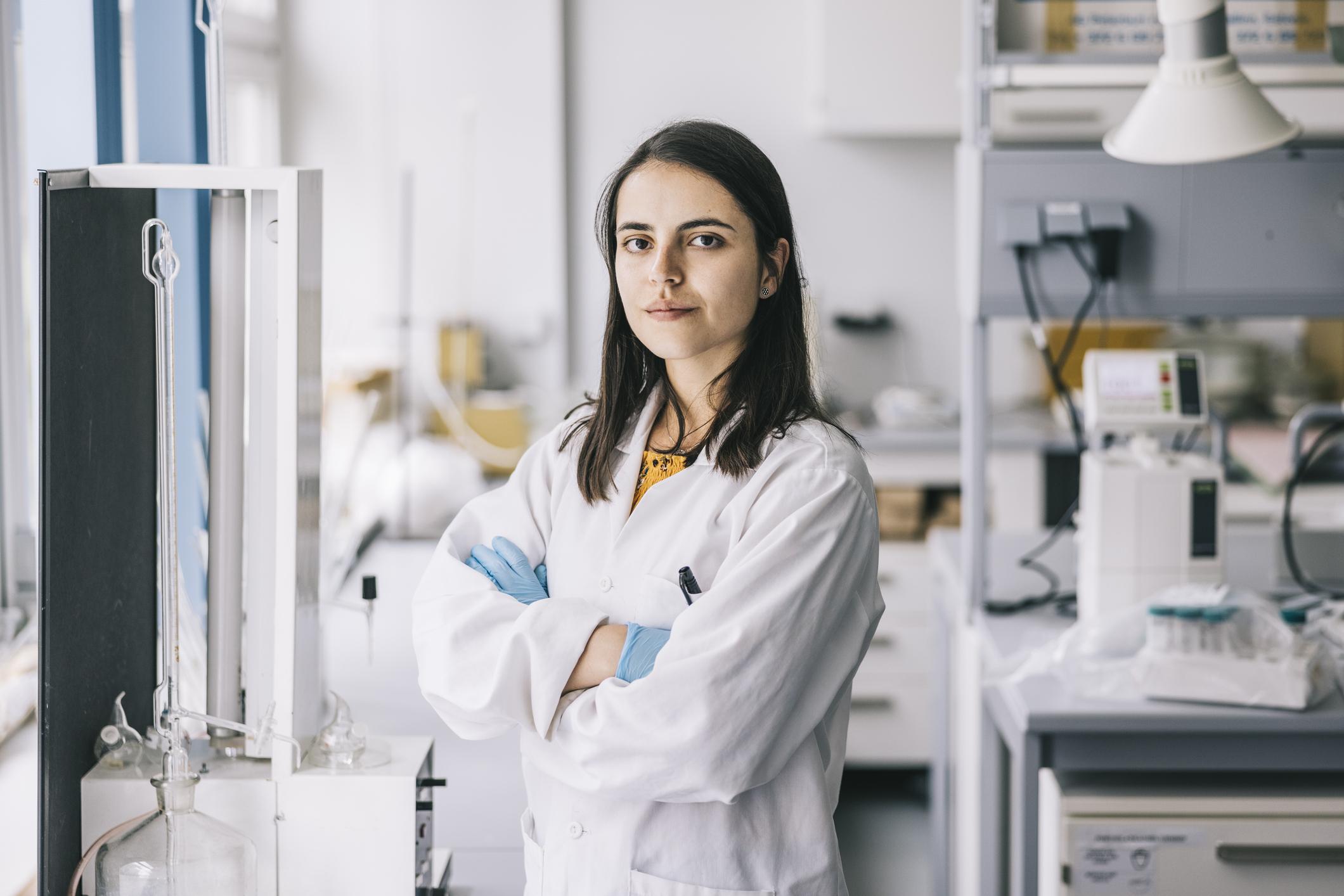 Researcher with her arms crossed in a lab