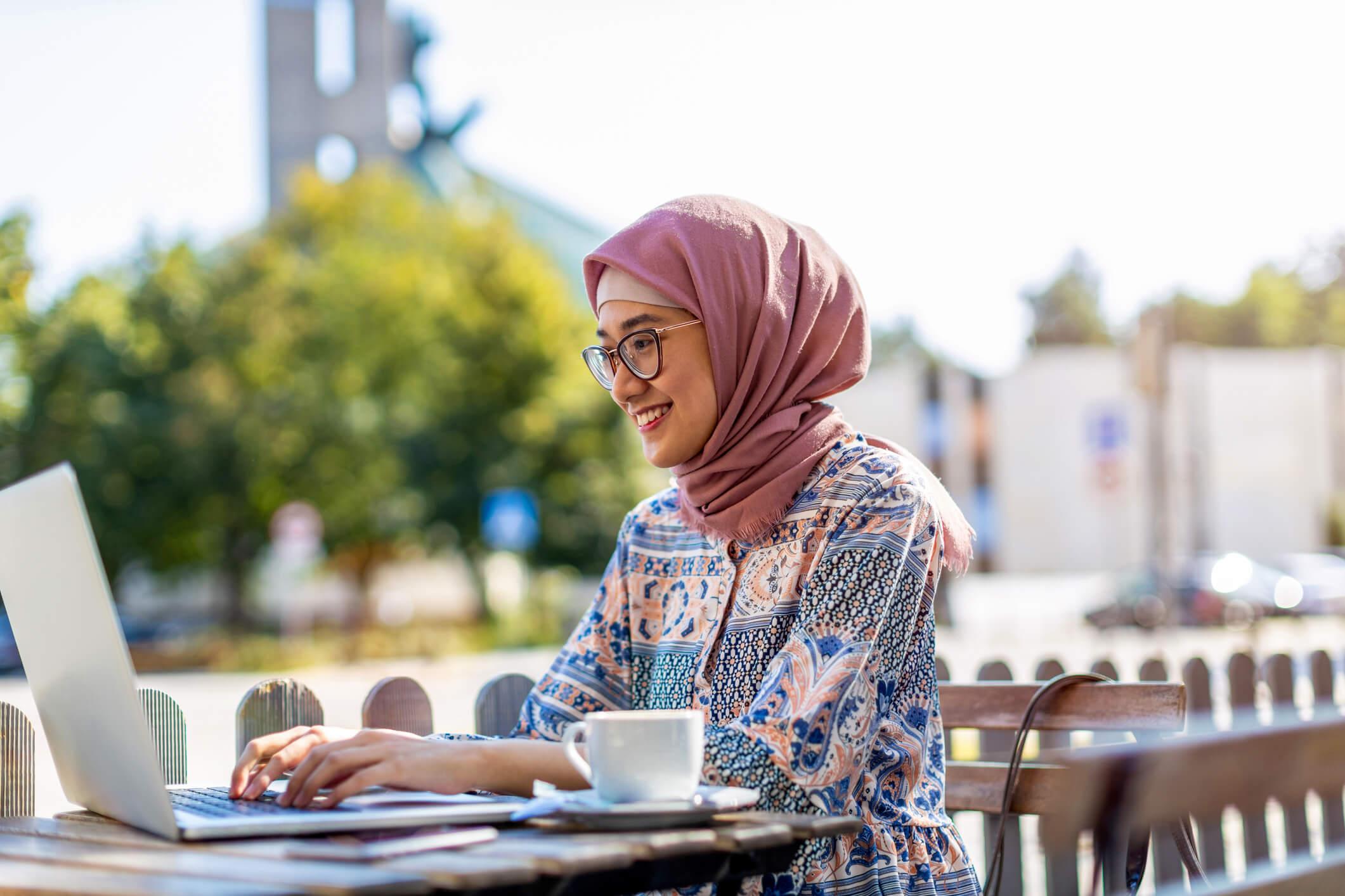 Woman sat outside using a laptop