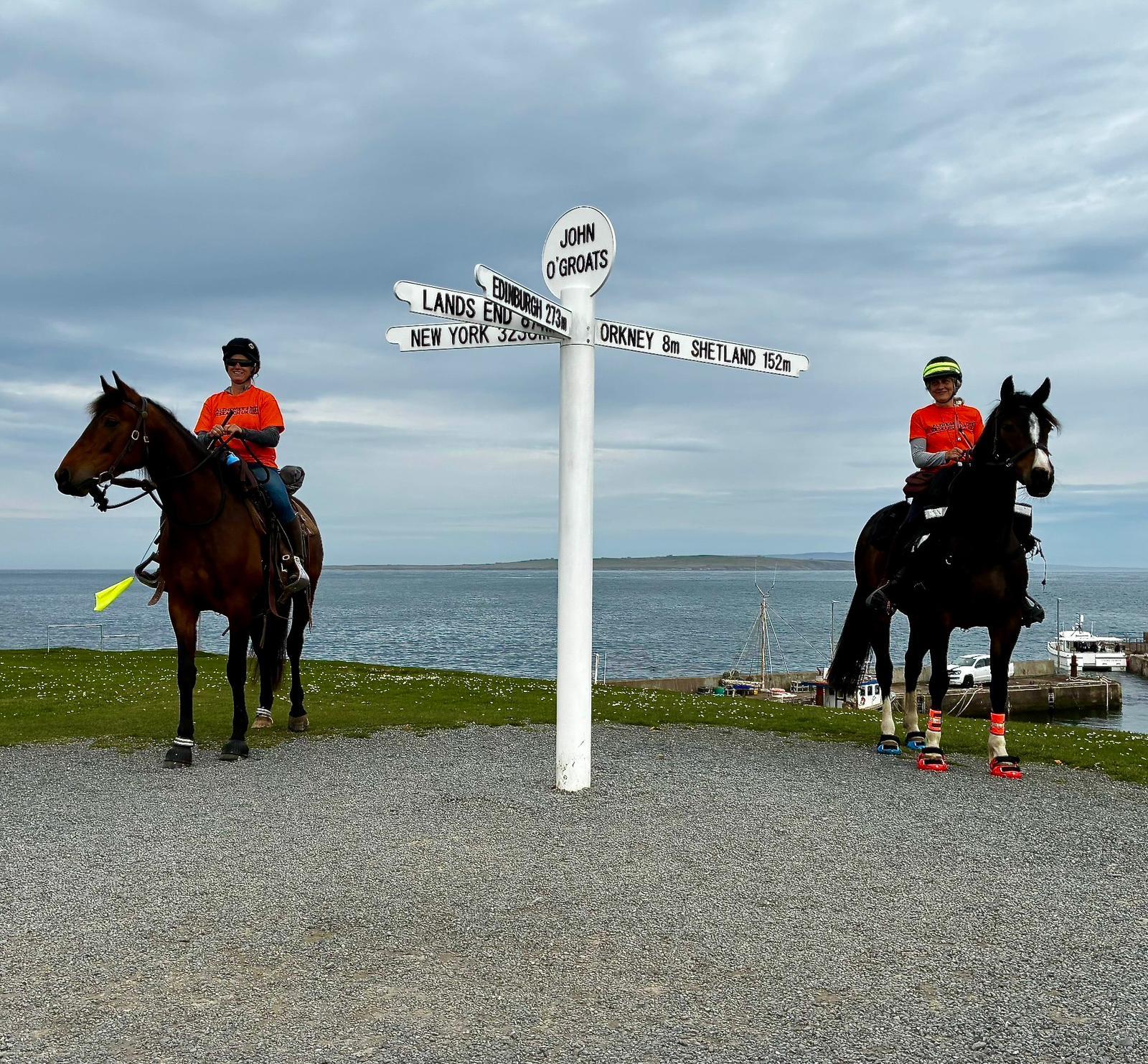 Jo & Alison on their horses at the John O'Groats sign