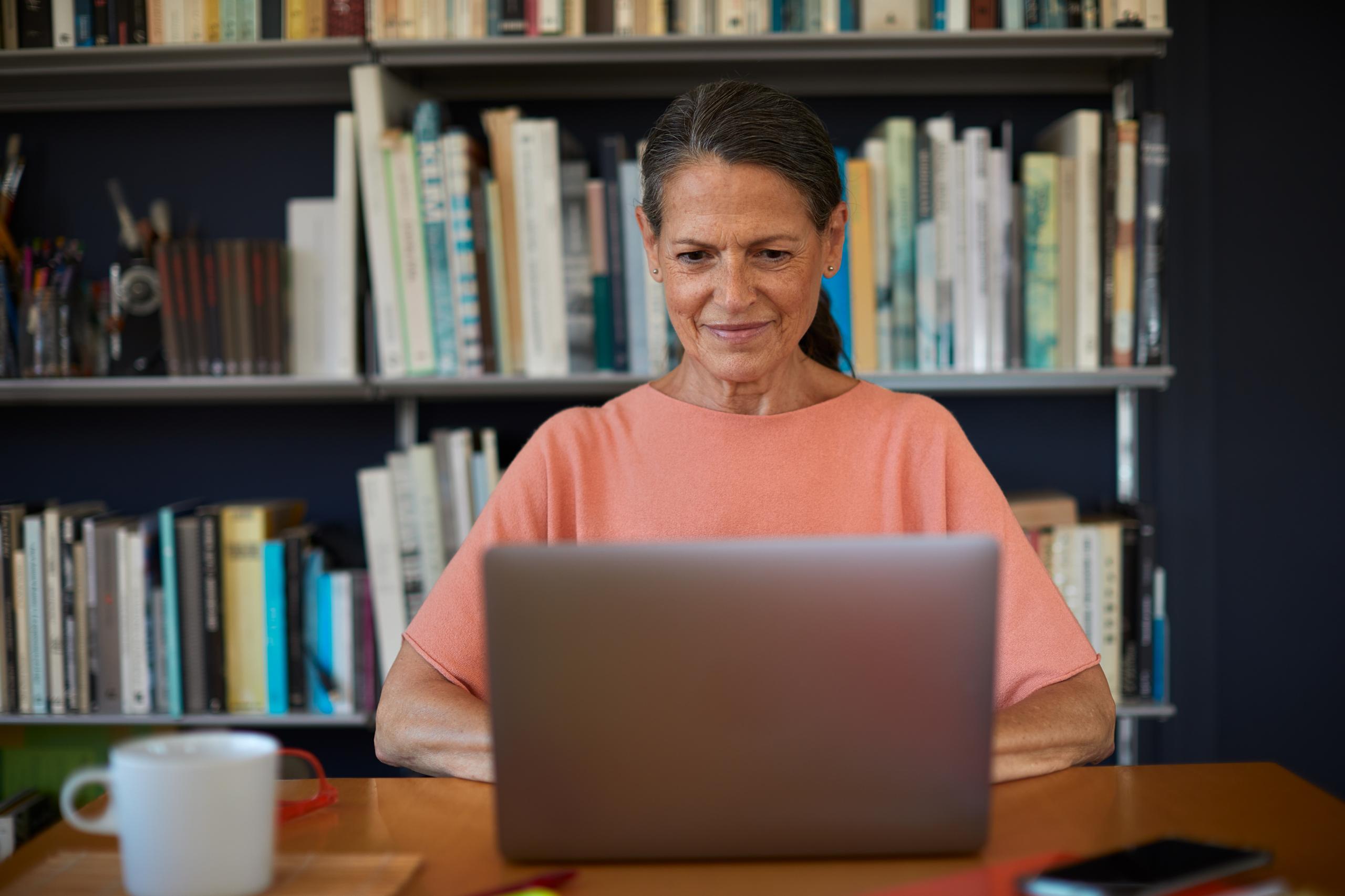 Woman on her laptop at a support group meeting