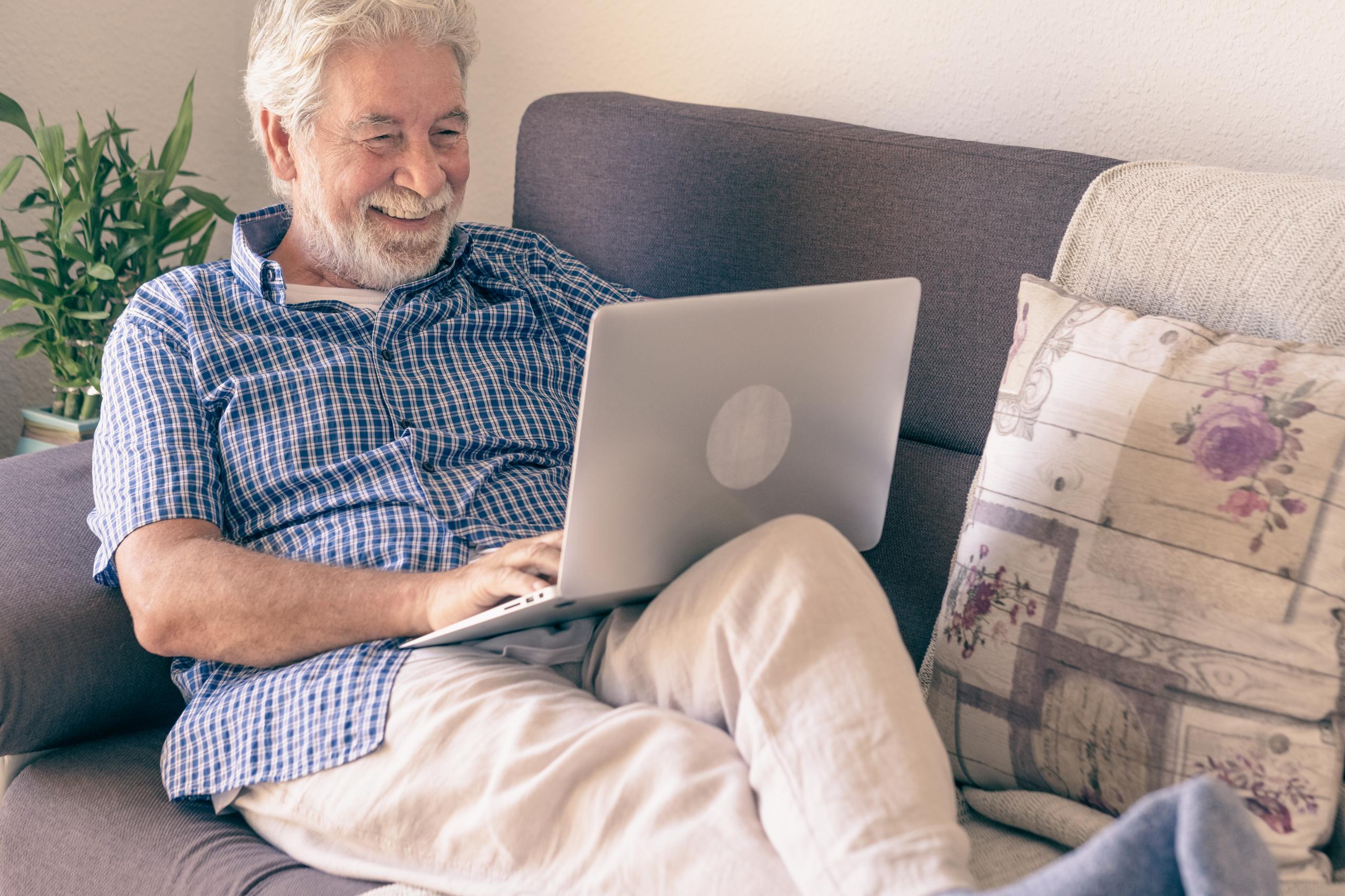 Man sitting on sofa on his laptop