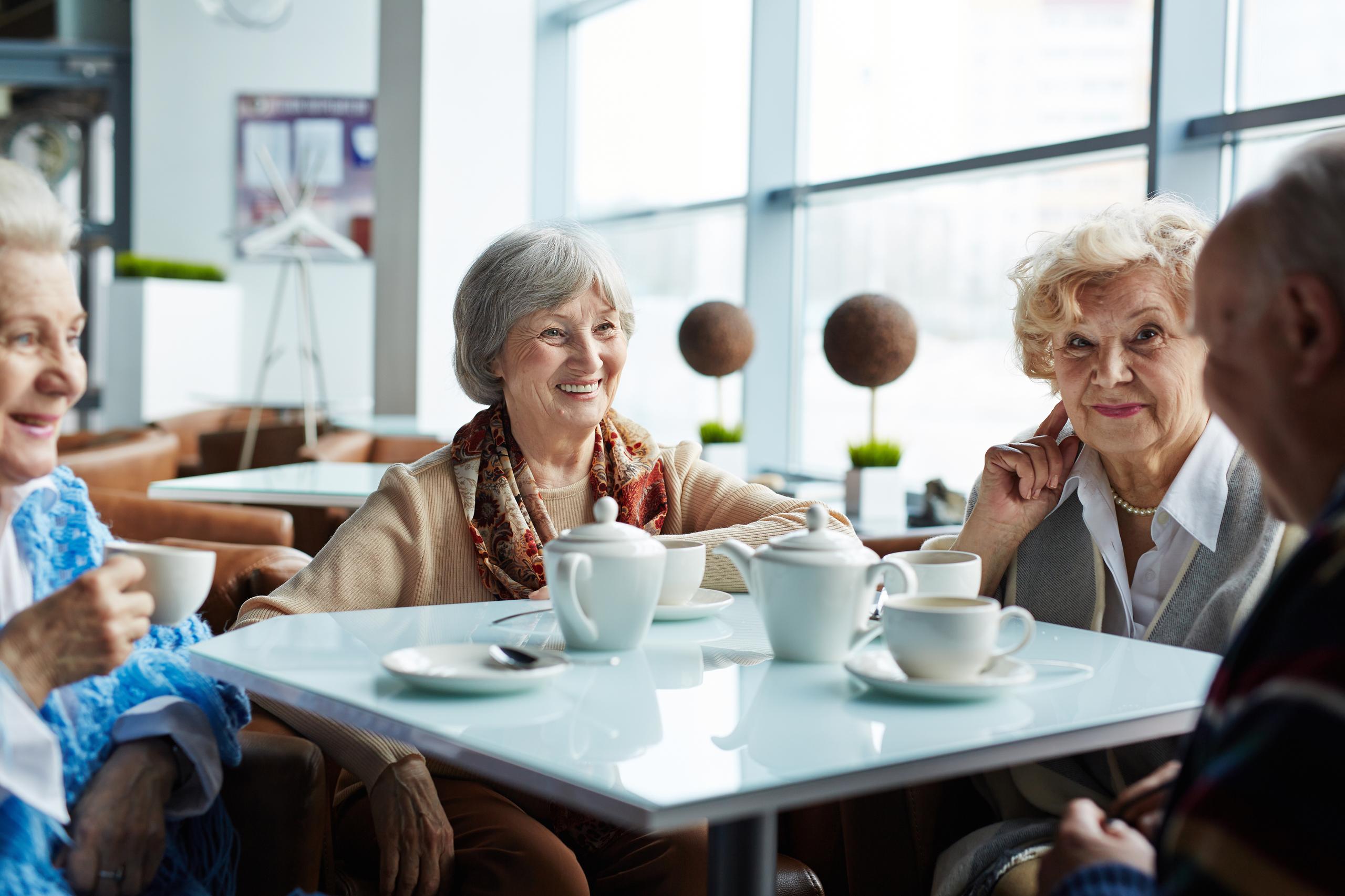 Group of people chatting over tea