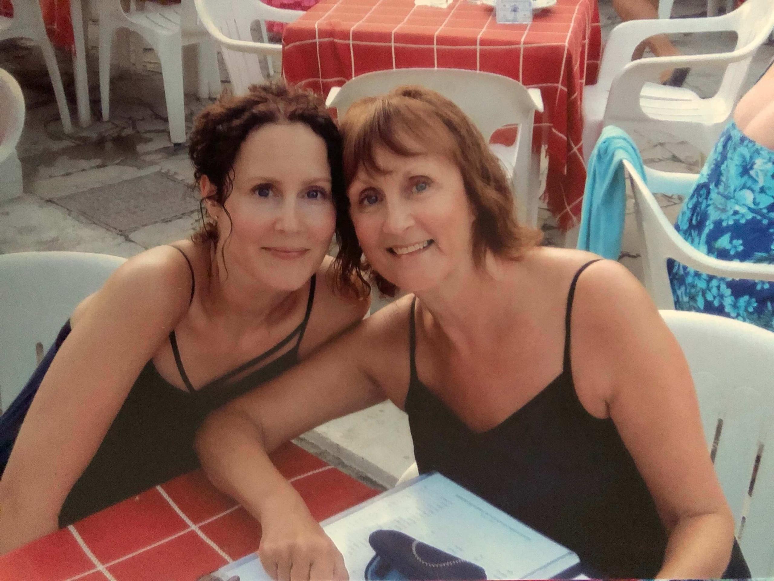 Two women sat at a table on holiday