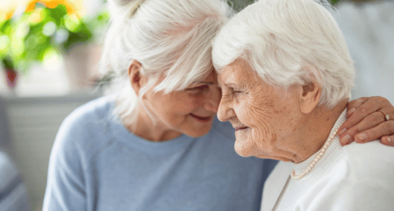A woman hugging her elderly mother