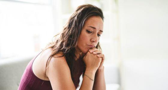 Woman sat looking pensive
