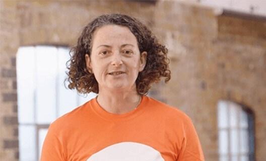 An exercise instructor in an orange t shirt