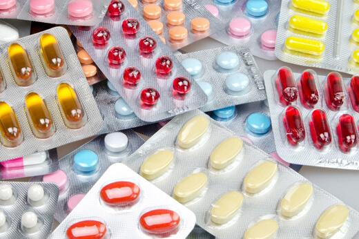 A collection of medicines and tablets on a table