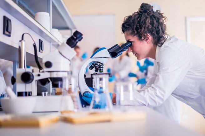 Woman using microscope