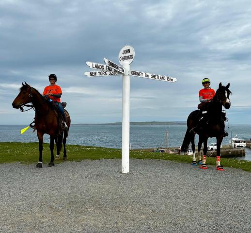 Jo & Alison on their horses at the John O'Groats sign