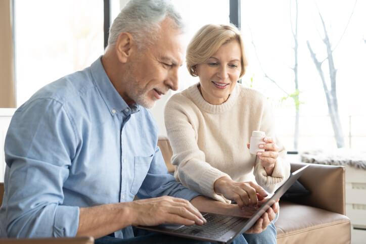 Senior couple looking at a laptop