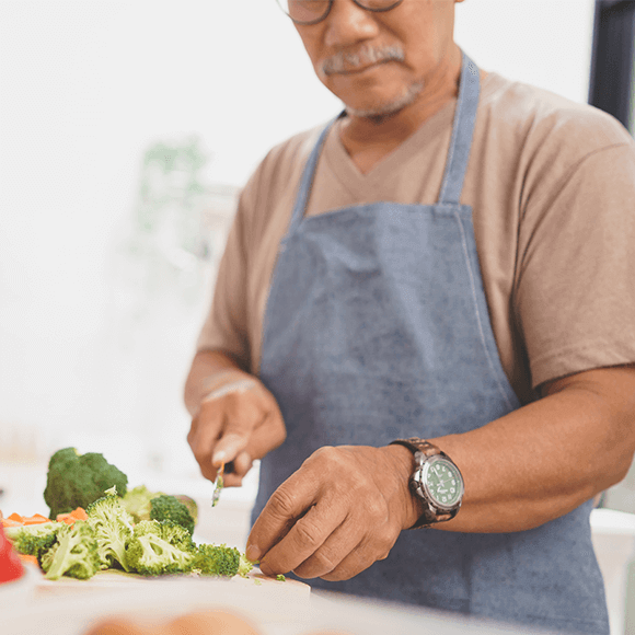 Man chopping up vegetables