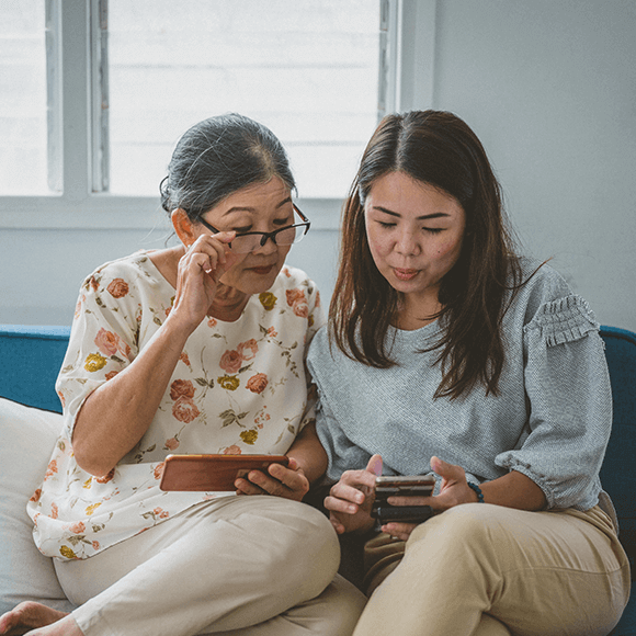 Two women looking at a smartphone