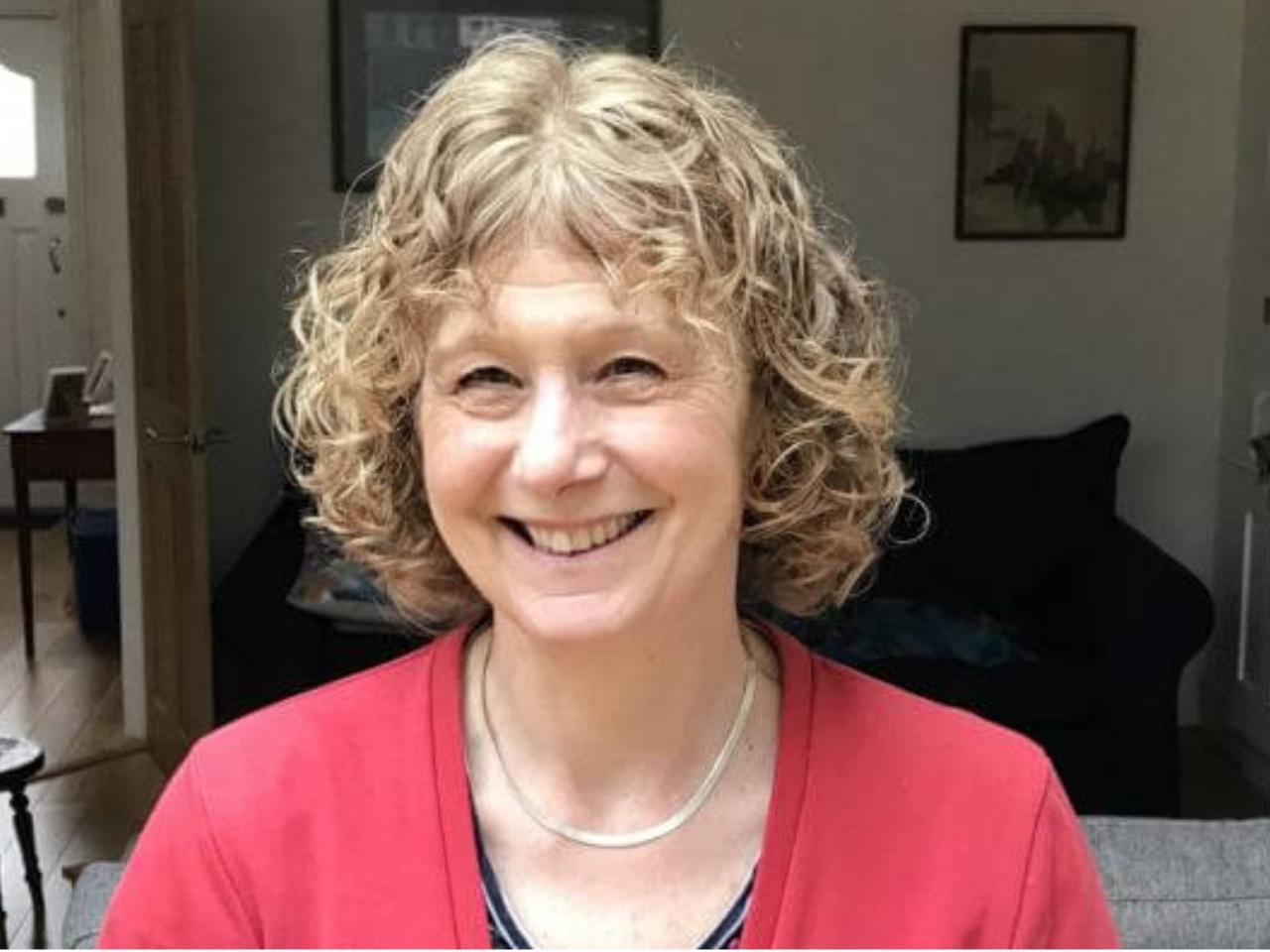 Woman in a red jumper smiling
