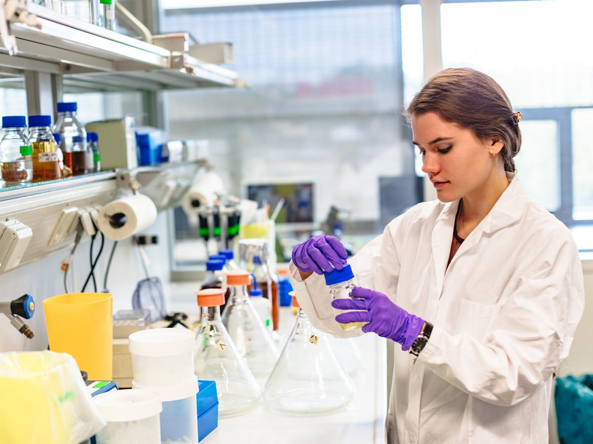 Researcher labelling a sample in a lab