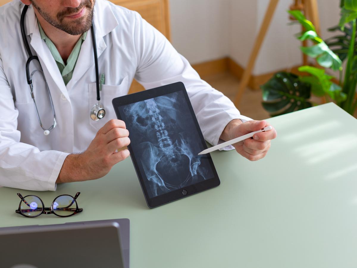 iPad showing a hip xray in doctors hands