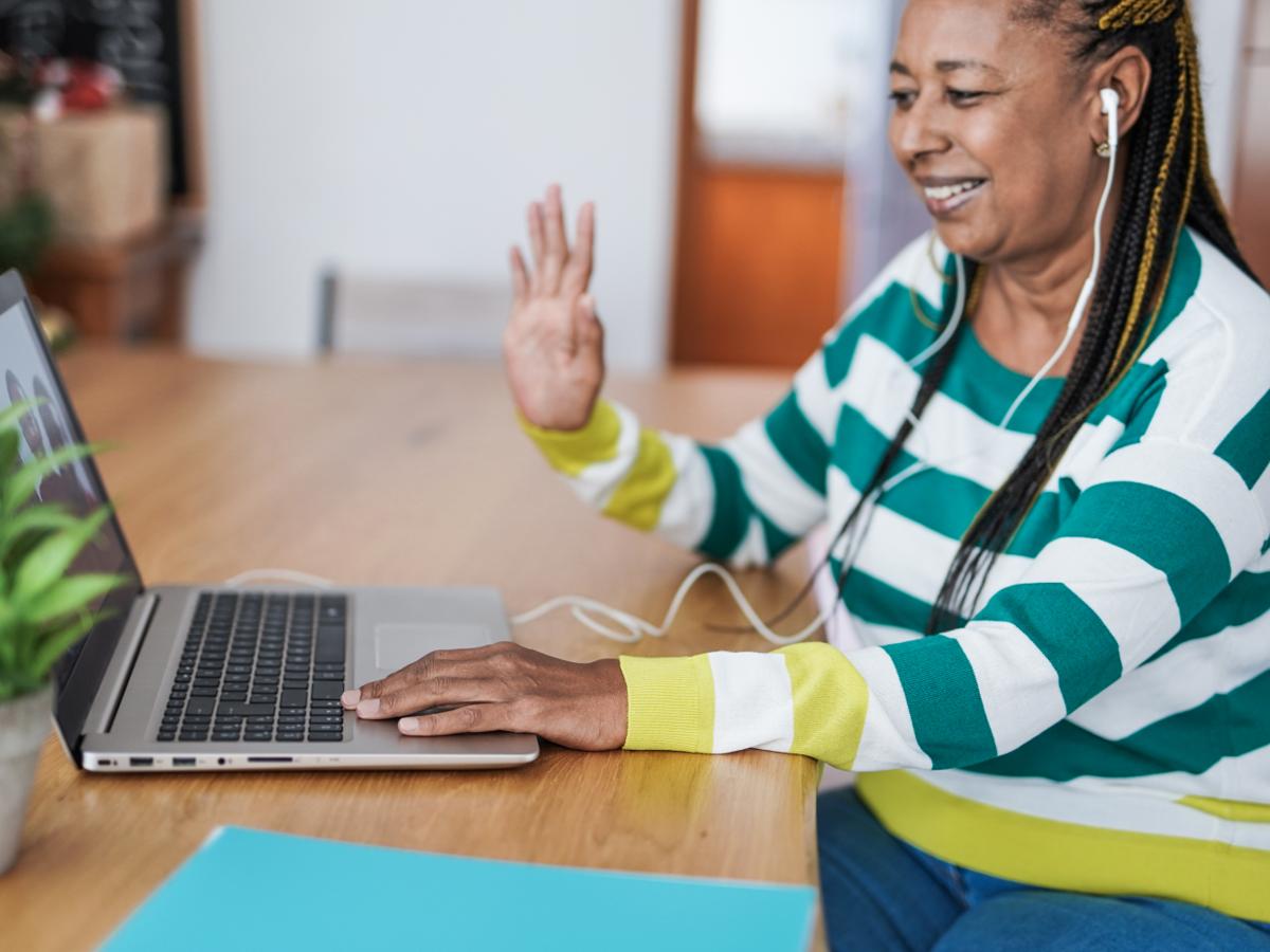 Woman smiling and waving on a video call