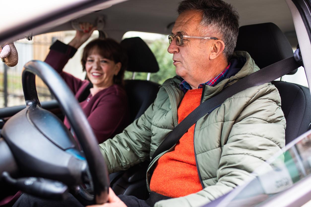 Man and woman driving in a car