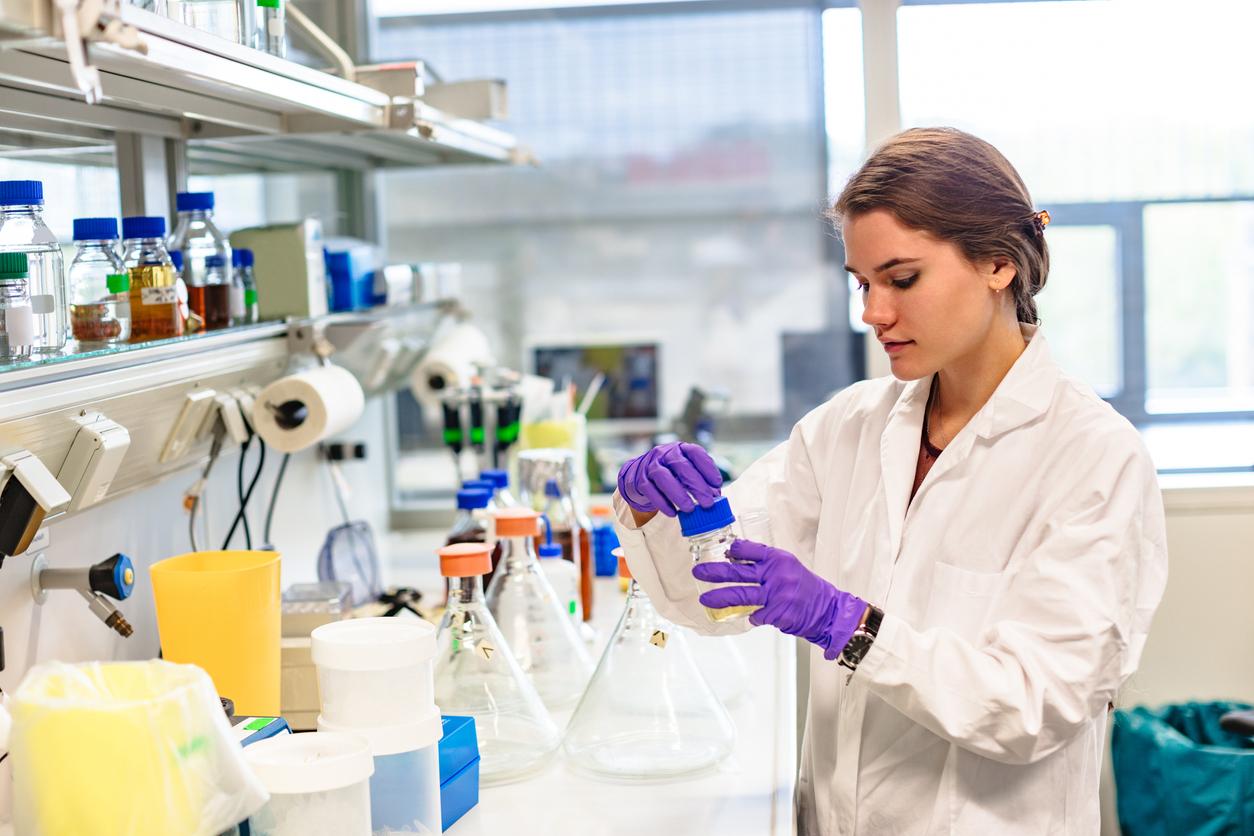 Researcher labelling a sample in a lab