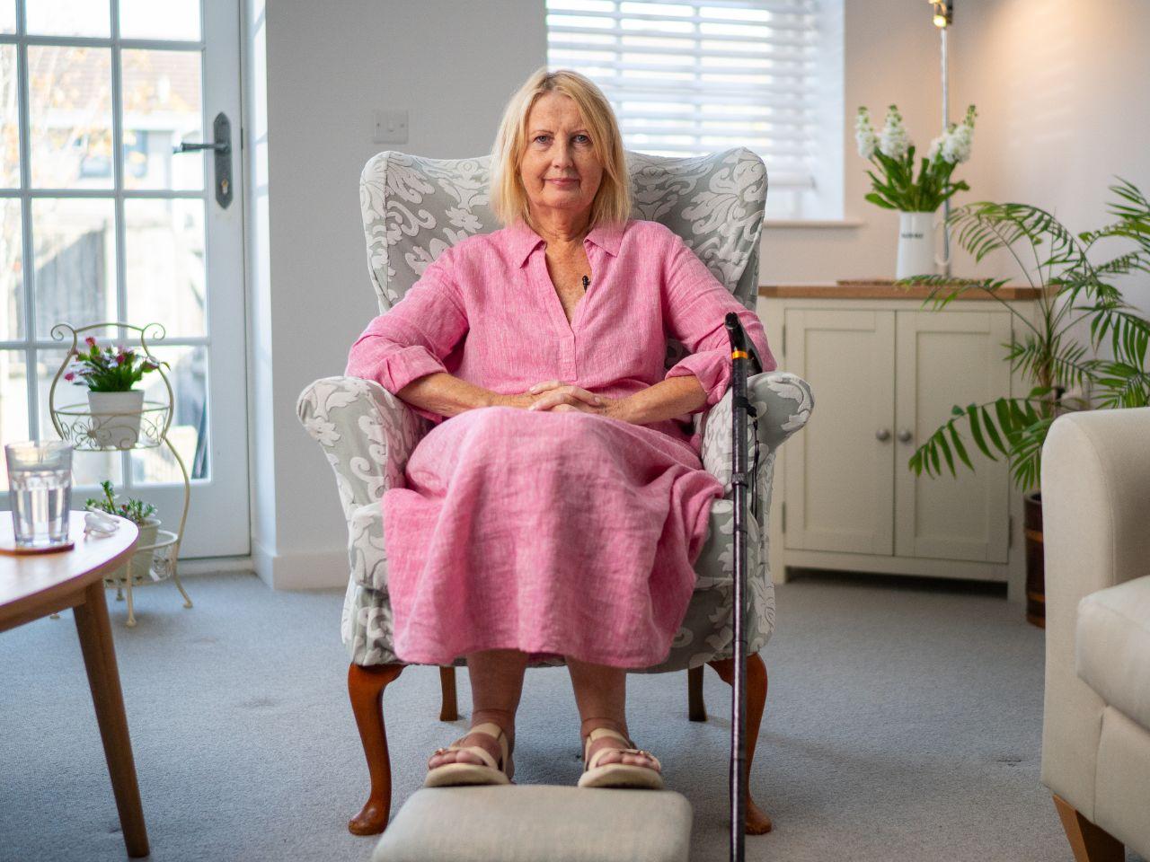 Lady in a chair wearing a pink dress