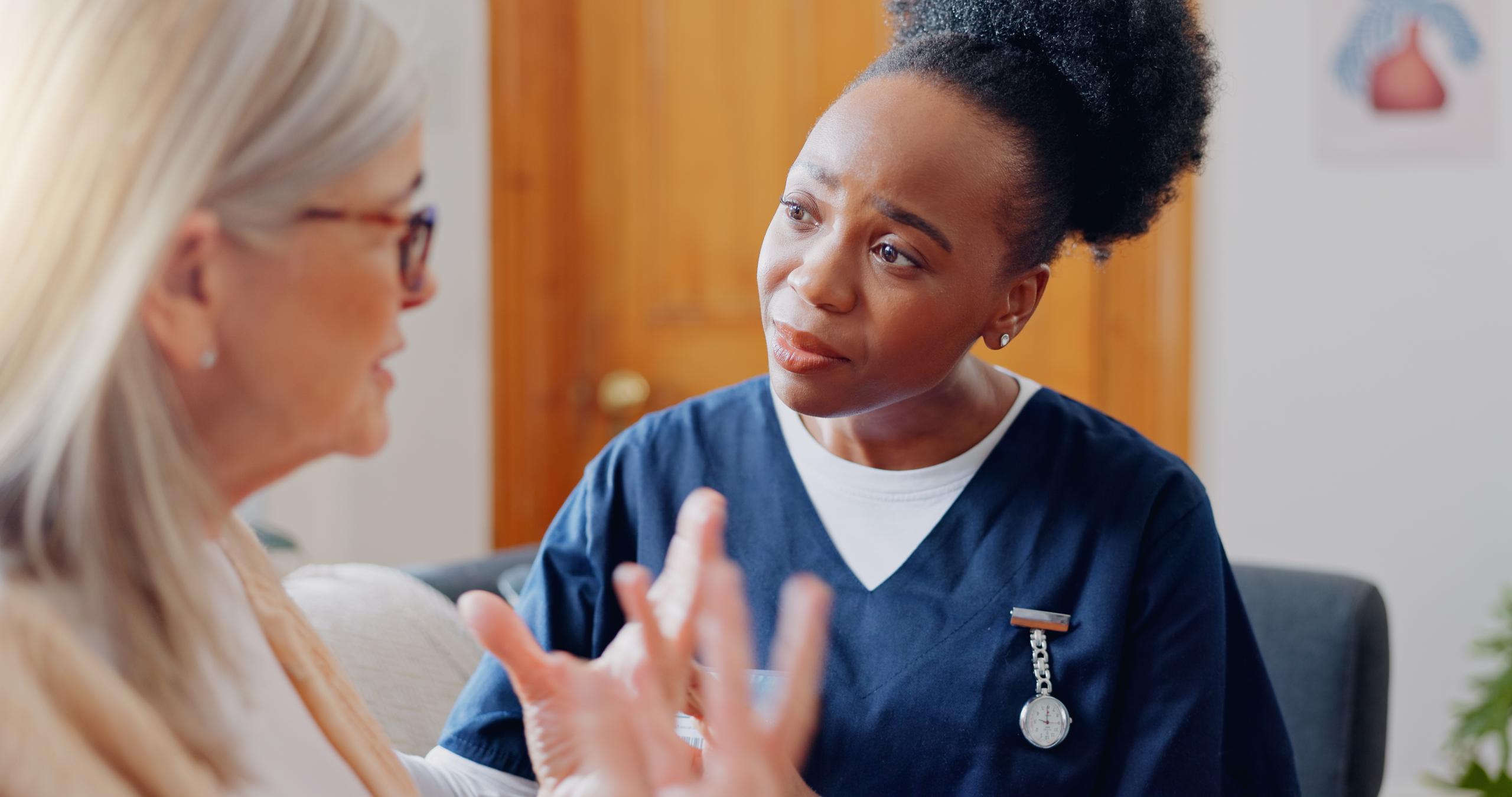 A healthcare professional listens carefully to a patient