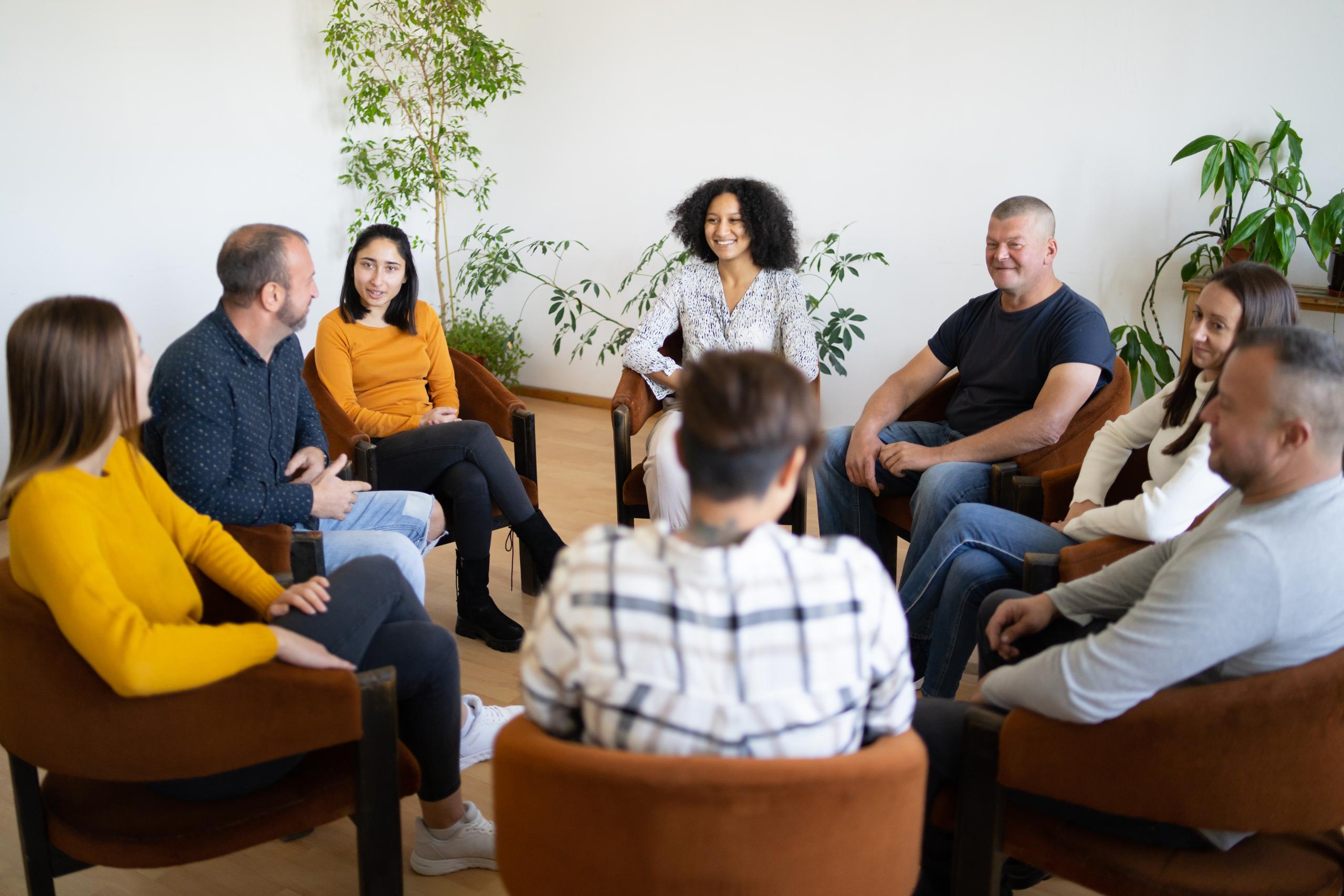 A group of people chatting together in a circle