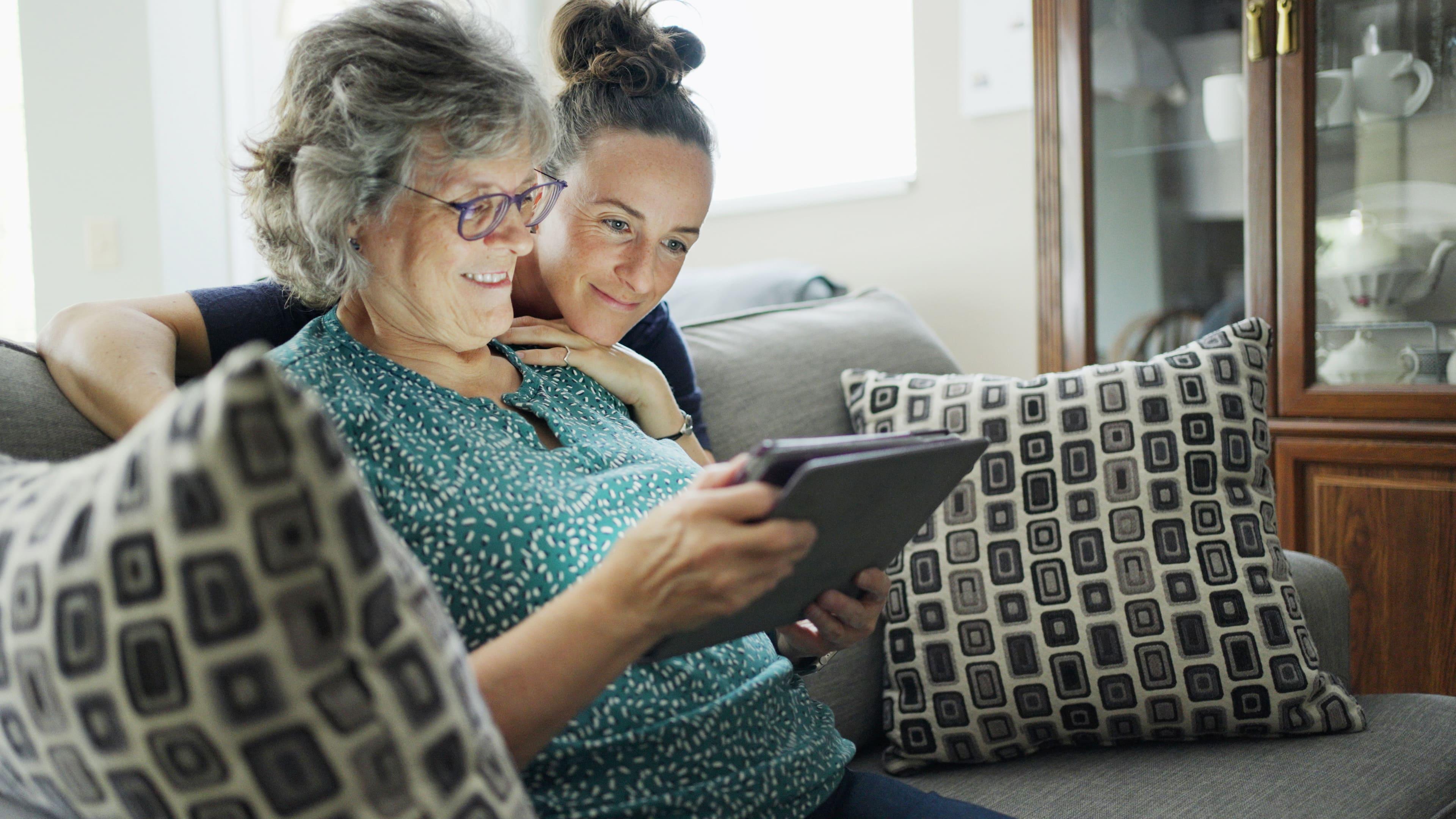 One younger and one older woman looking at tablet device