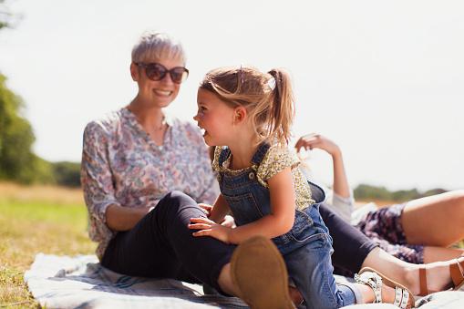 A grandmother and grandchild sitting in the sun