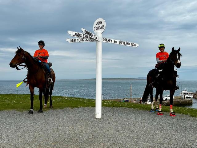 Jo & Alison on their horses at the John O'Groats sign