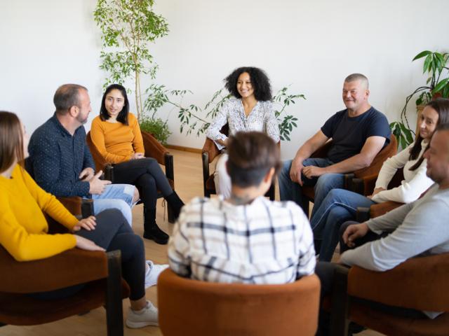 A group of people chatting together in a circle