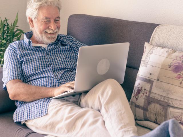 Man sitting on sofa on his laptop