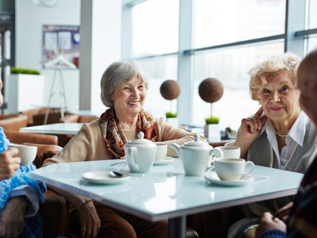 Group of people chatting over tea