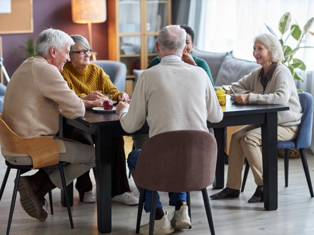 Group of people chatting over lunch