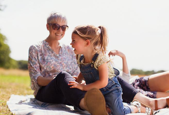 A grandmother and grandchild sitting in the sun