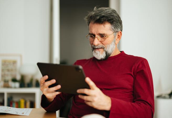 Man sat down using tablet device