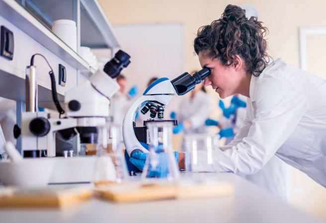 Woman using microscope