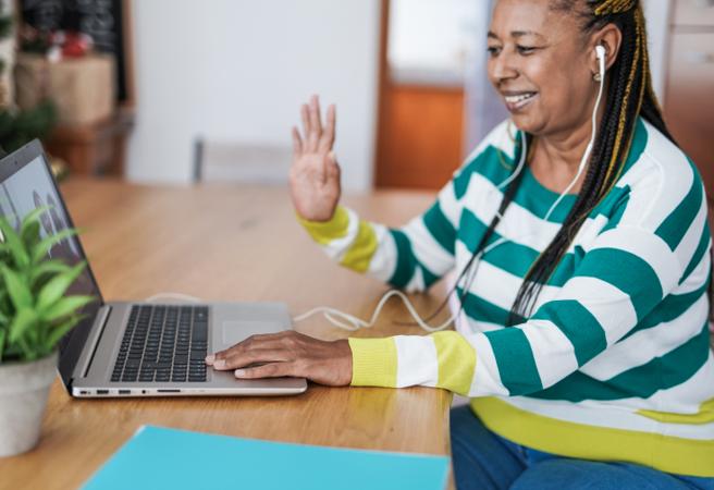 Woman smiling and waving on a video call