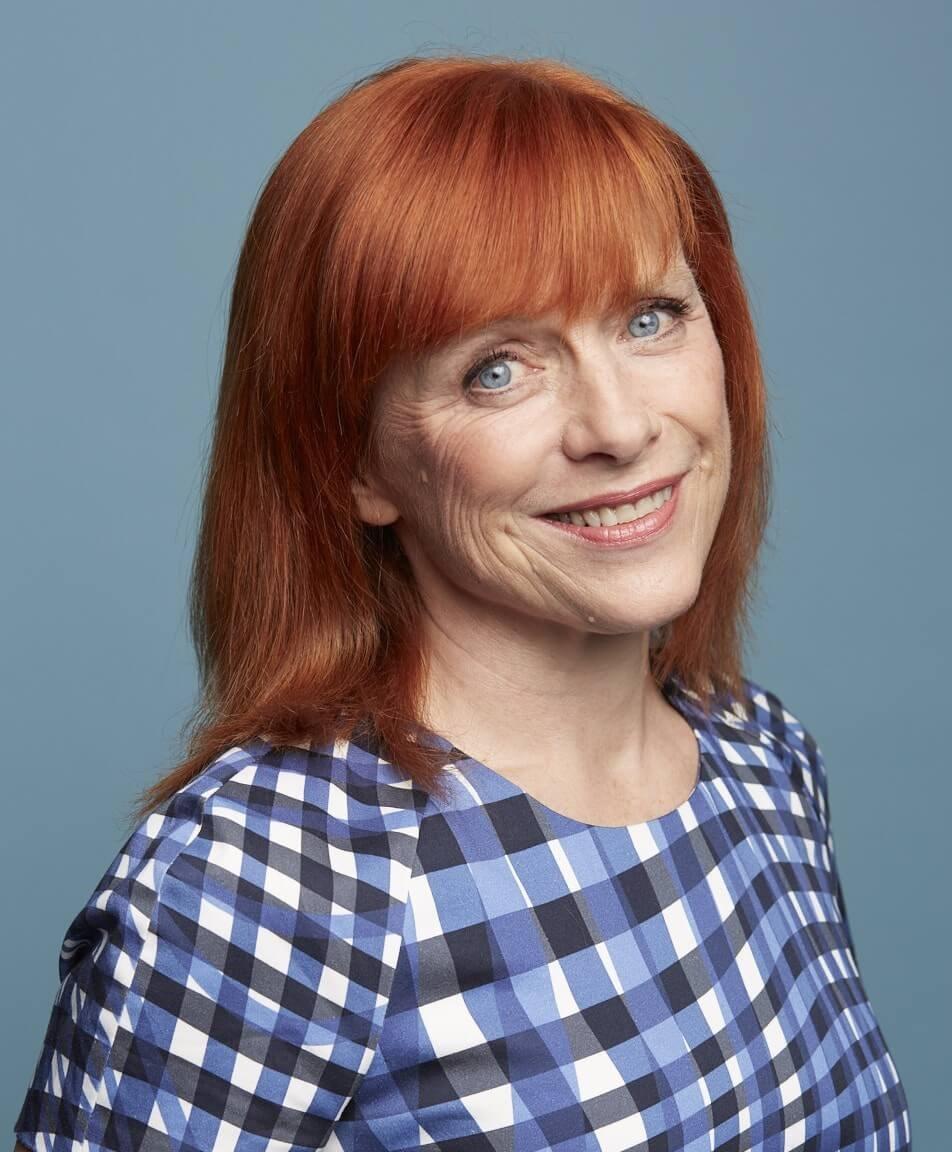 Sarah Jarvis, Royal Osteoporosis Society Ambassador, smiling, wearing a patterned top.